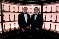 Oltmanns & Rosas in front of Oscars trophy case at 79th Annual Academy Awards
