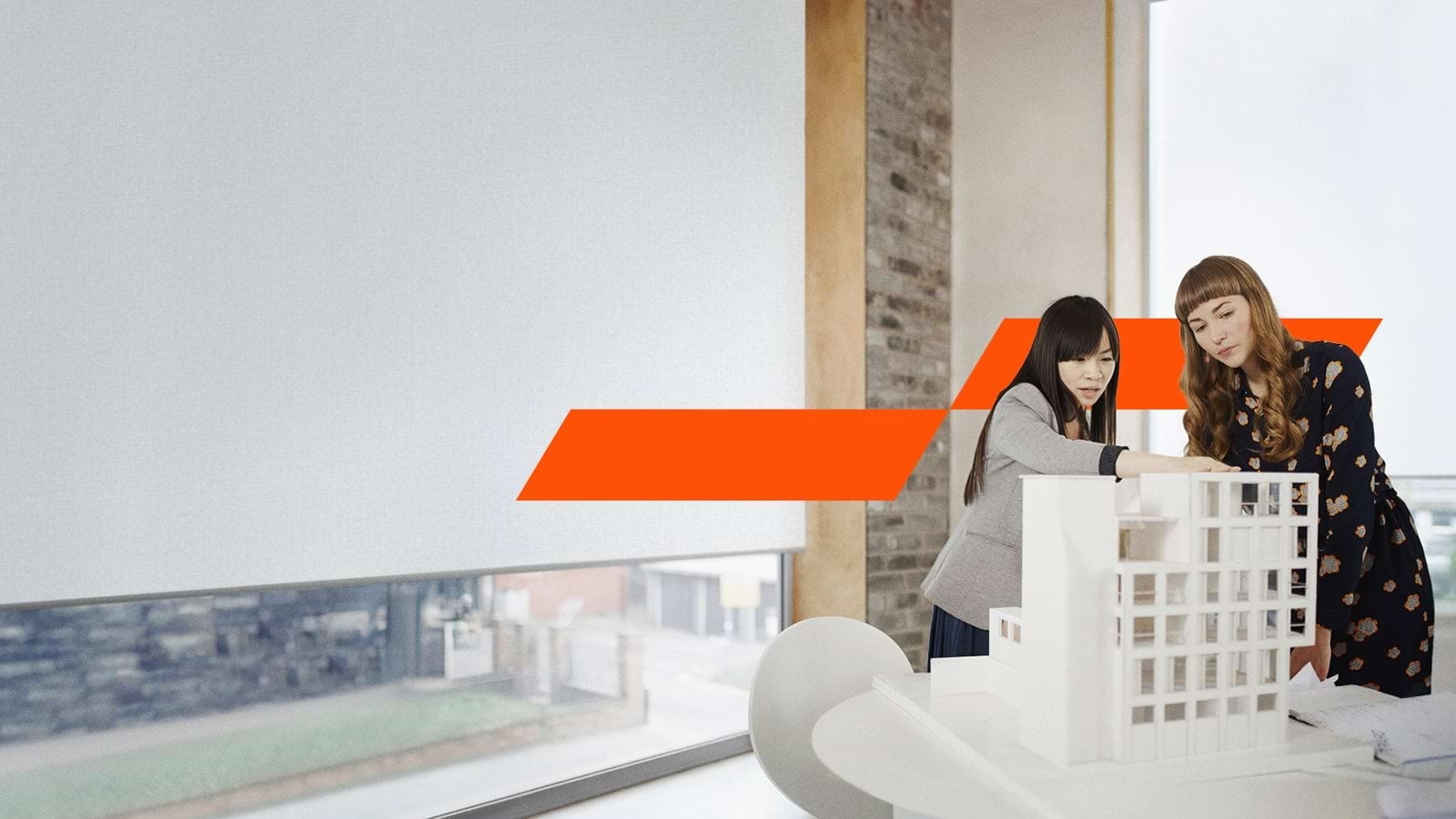 Two women having a discussion over a diorama