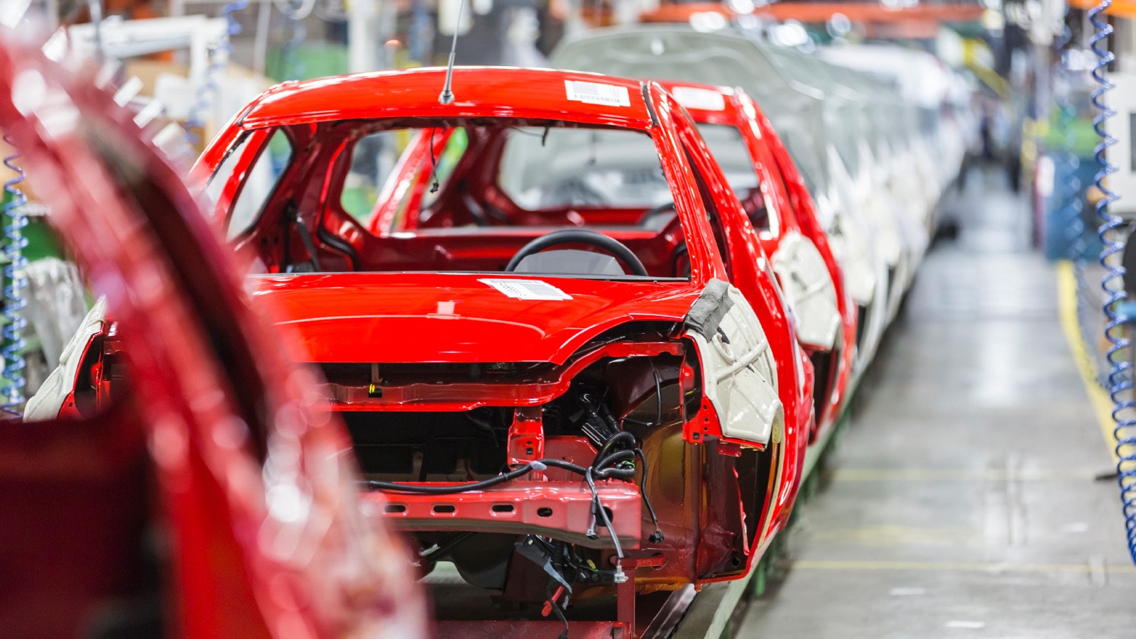 Image of a car being made in a factory.
