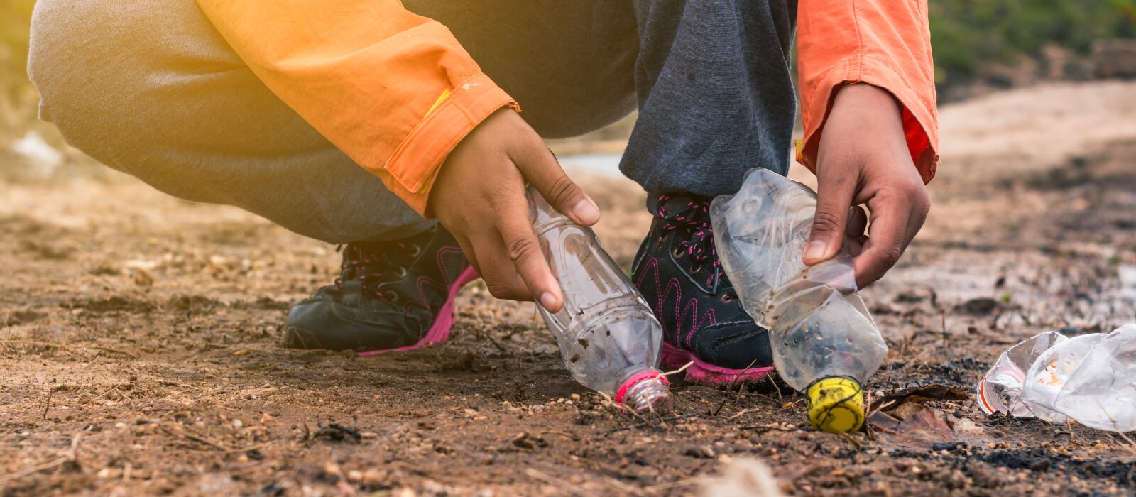 Man picking up bottles