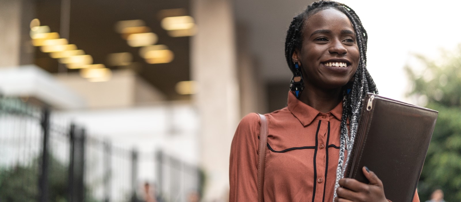 Business woman walking with folder