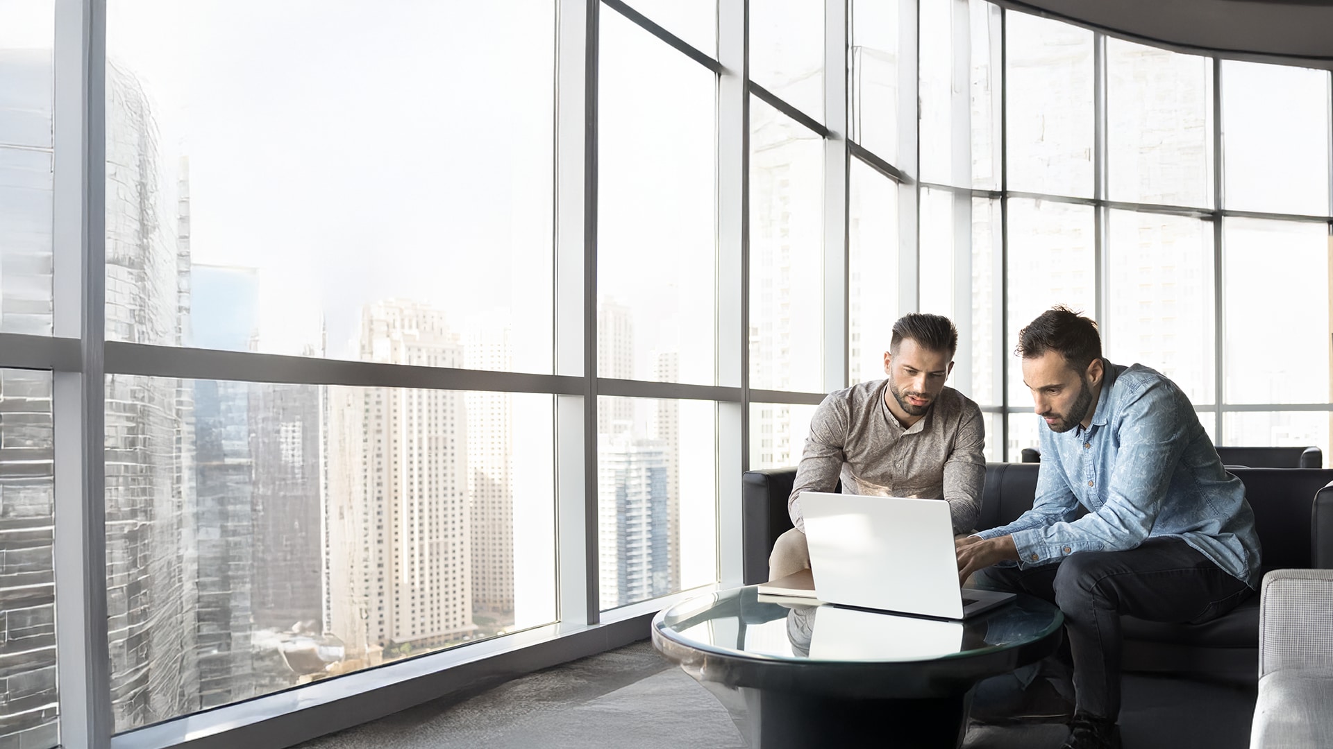 Kaks meest istumas arvuti taga ja arutamas ekraanil näha olevat