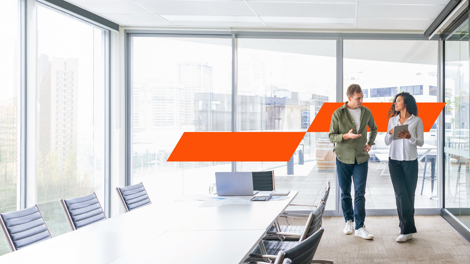 a man and woman walking and working together in the office