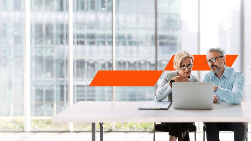 two coworkers working on a computer