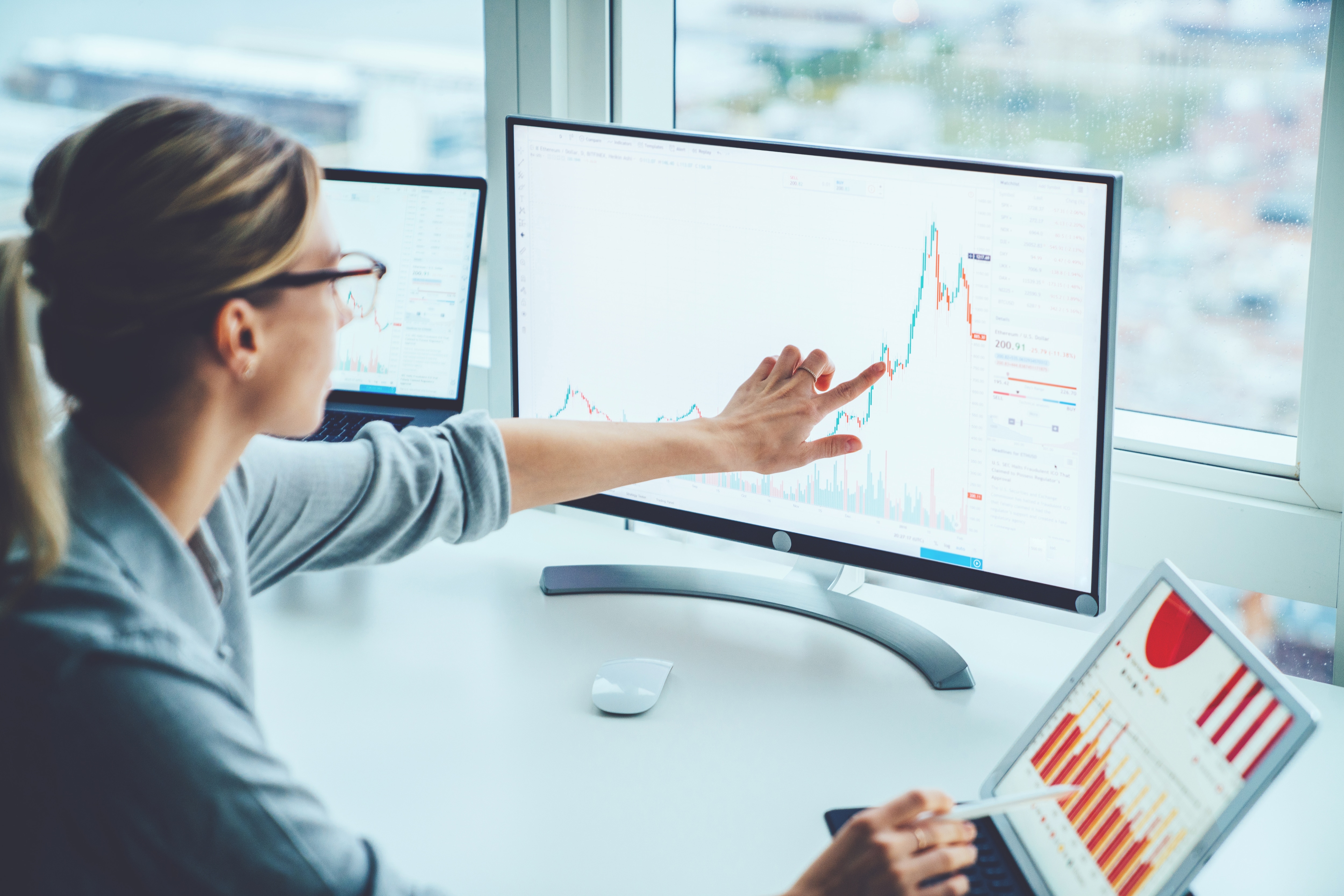 Woman pointing at computer screen