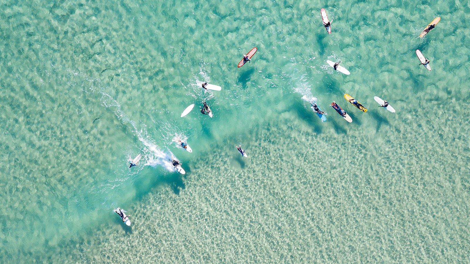 crystal clear waters with surfers
