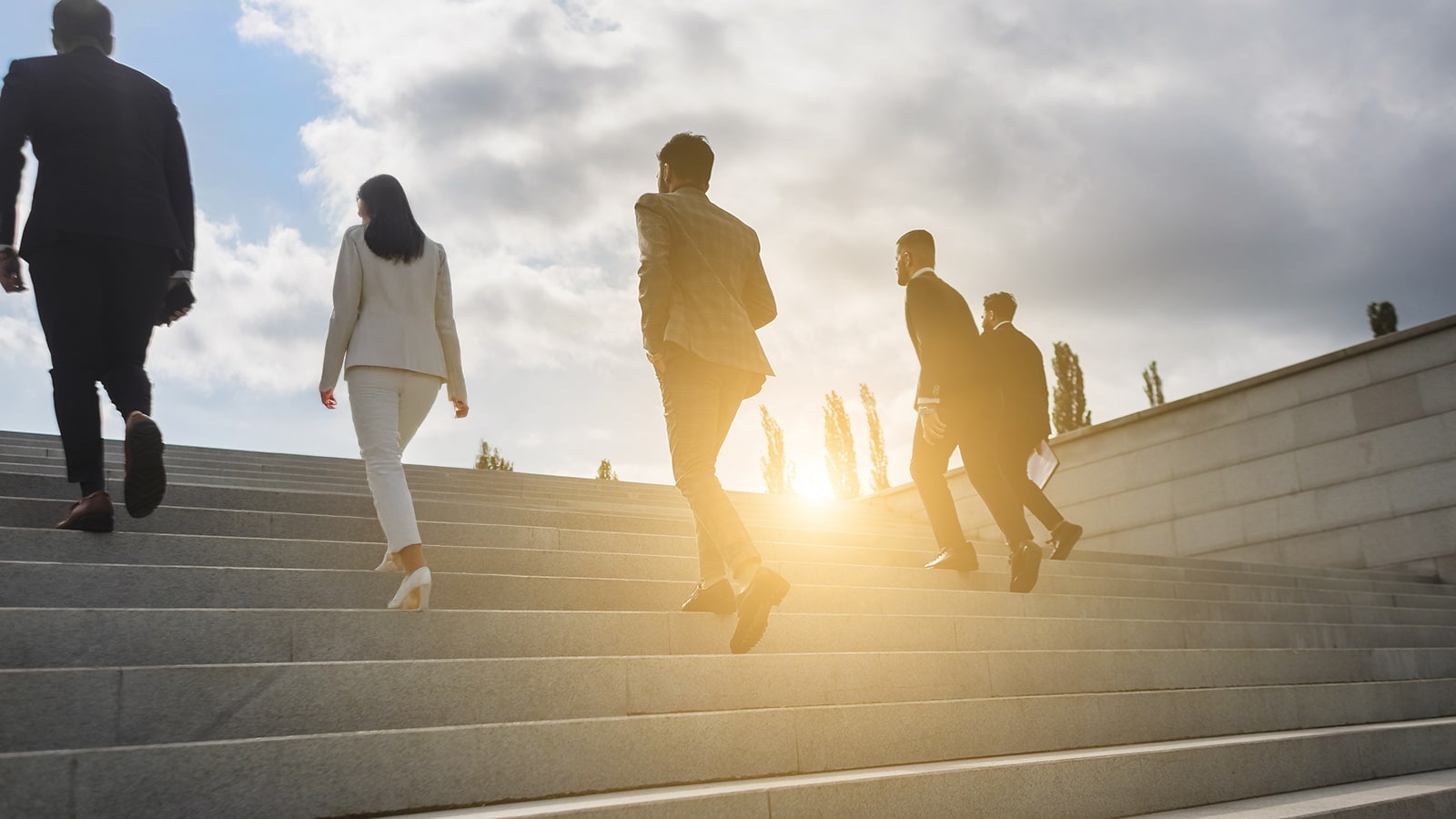 Business people climb steps of the city stairs