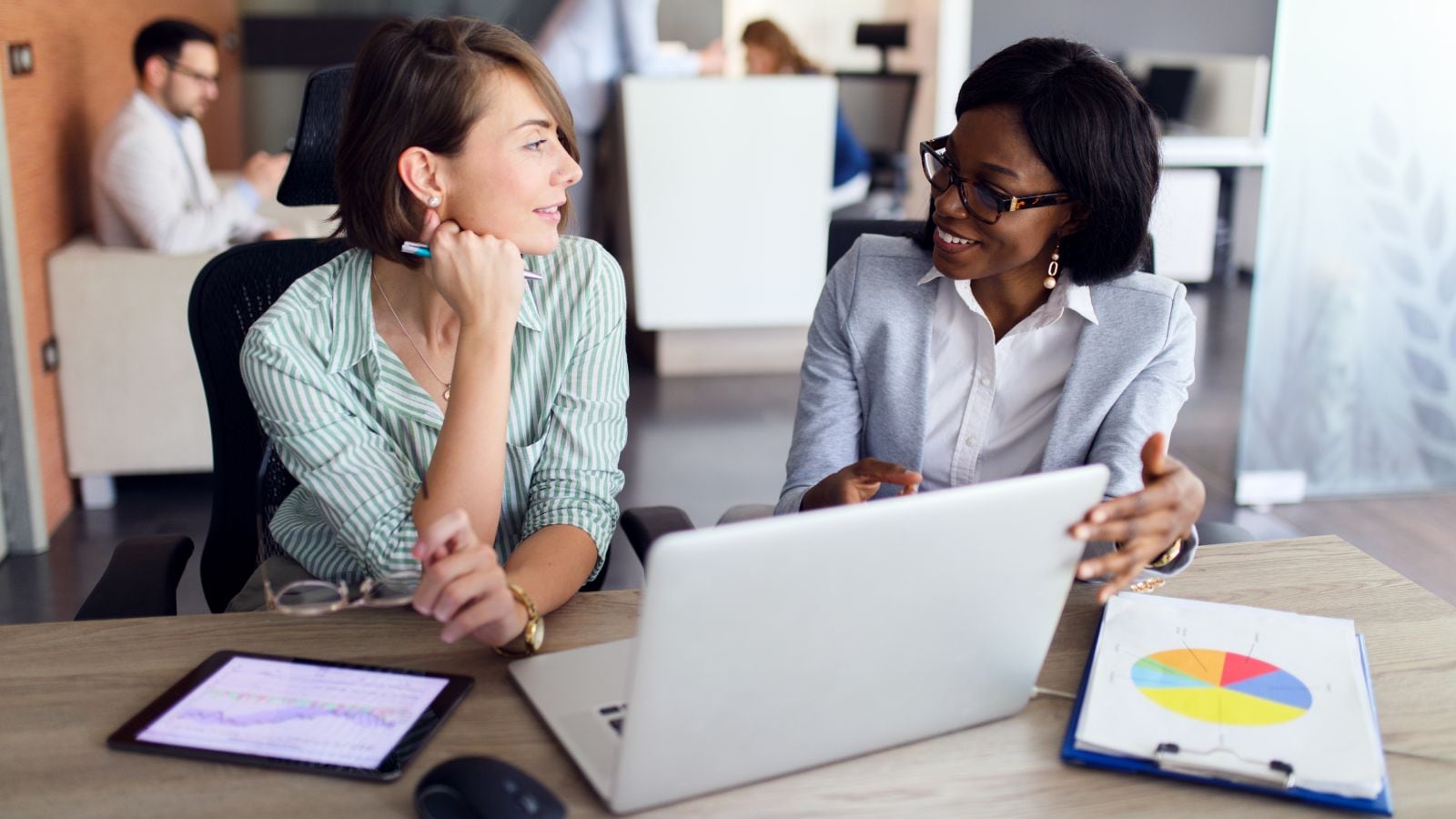 Businesswomen with laptop and digital tablet