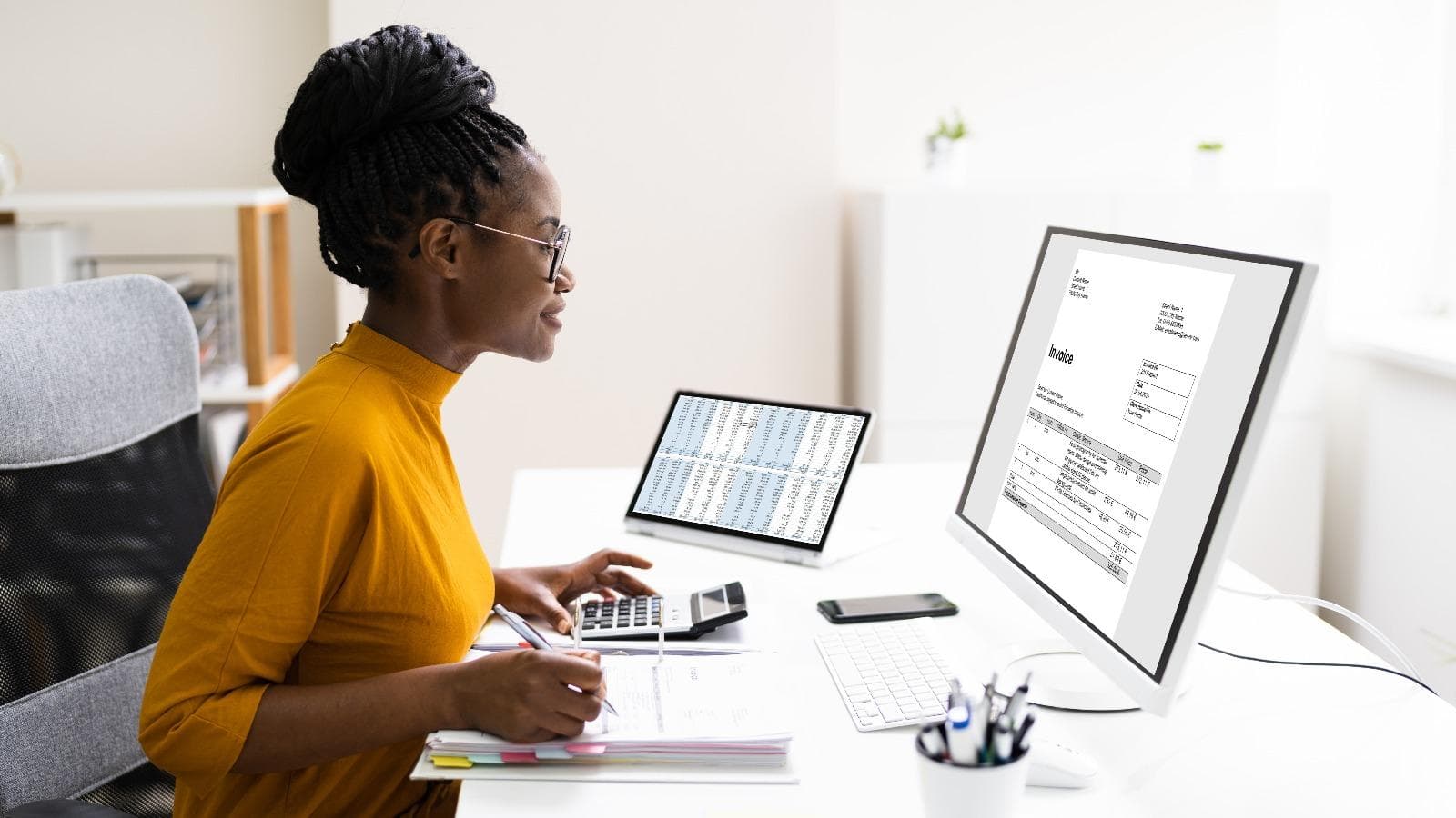 Lady sitting a desk looking at a computer monitor