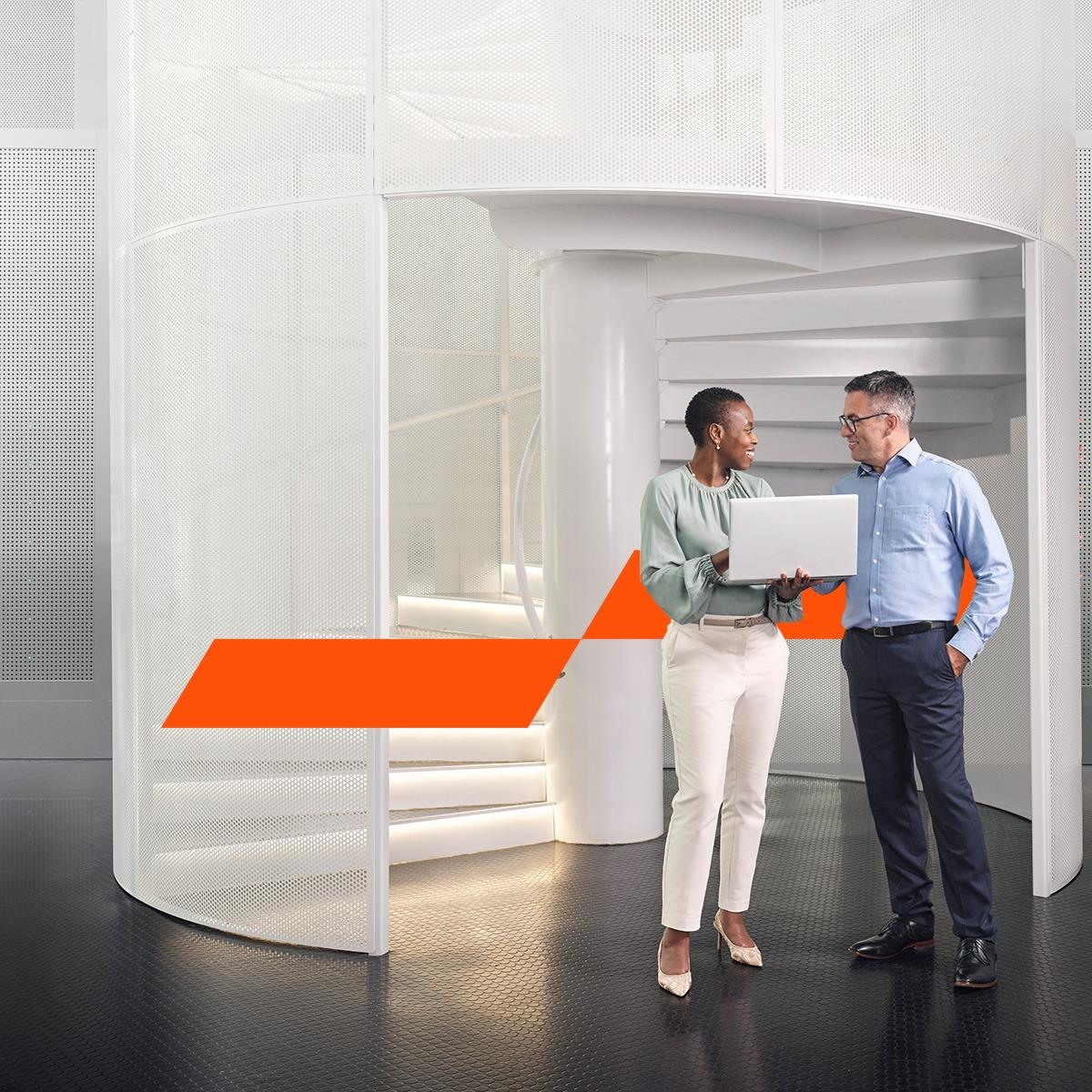 Two colleagues looking at a laptop