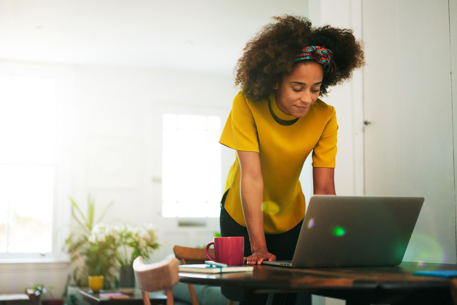 Image of a woman reading about the Nigeria summer reading list on her computer.