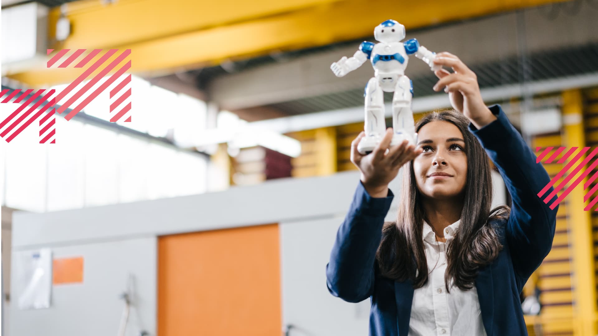 Young woman working in distribution warehouse, looking at toy robot
