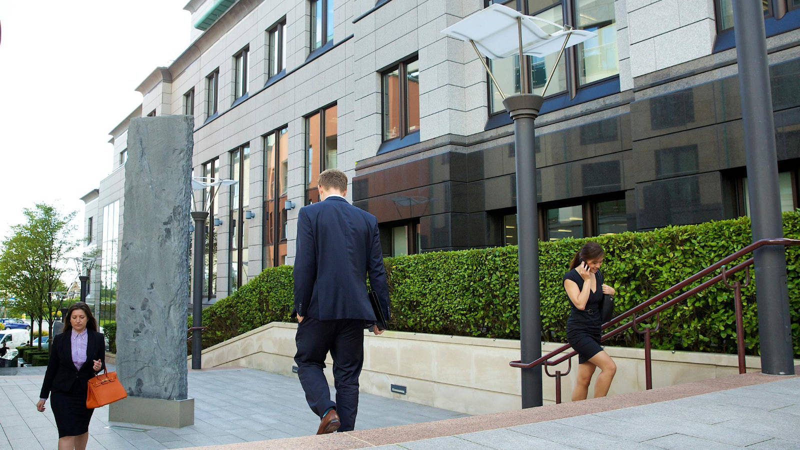 people walking outside office building