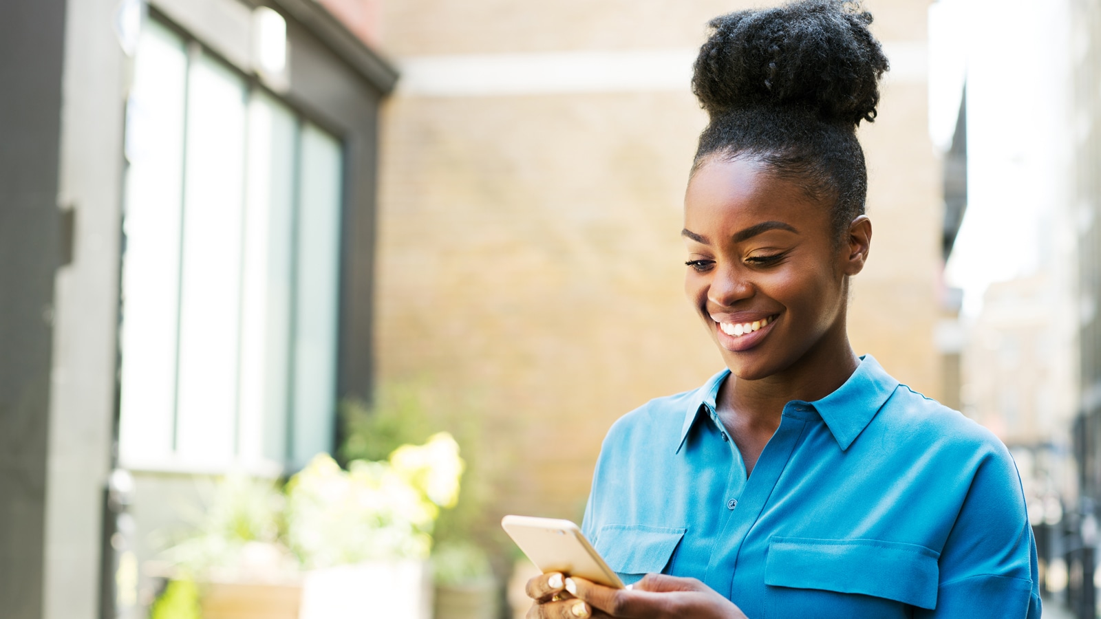 Girl standing looking at her phone