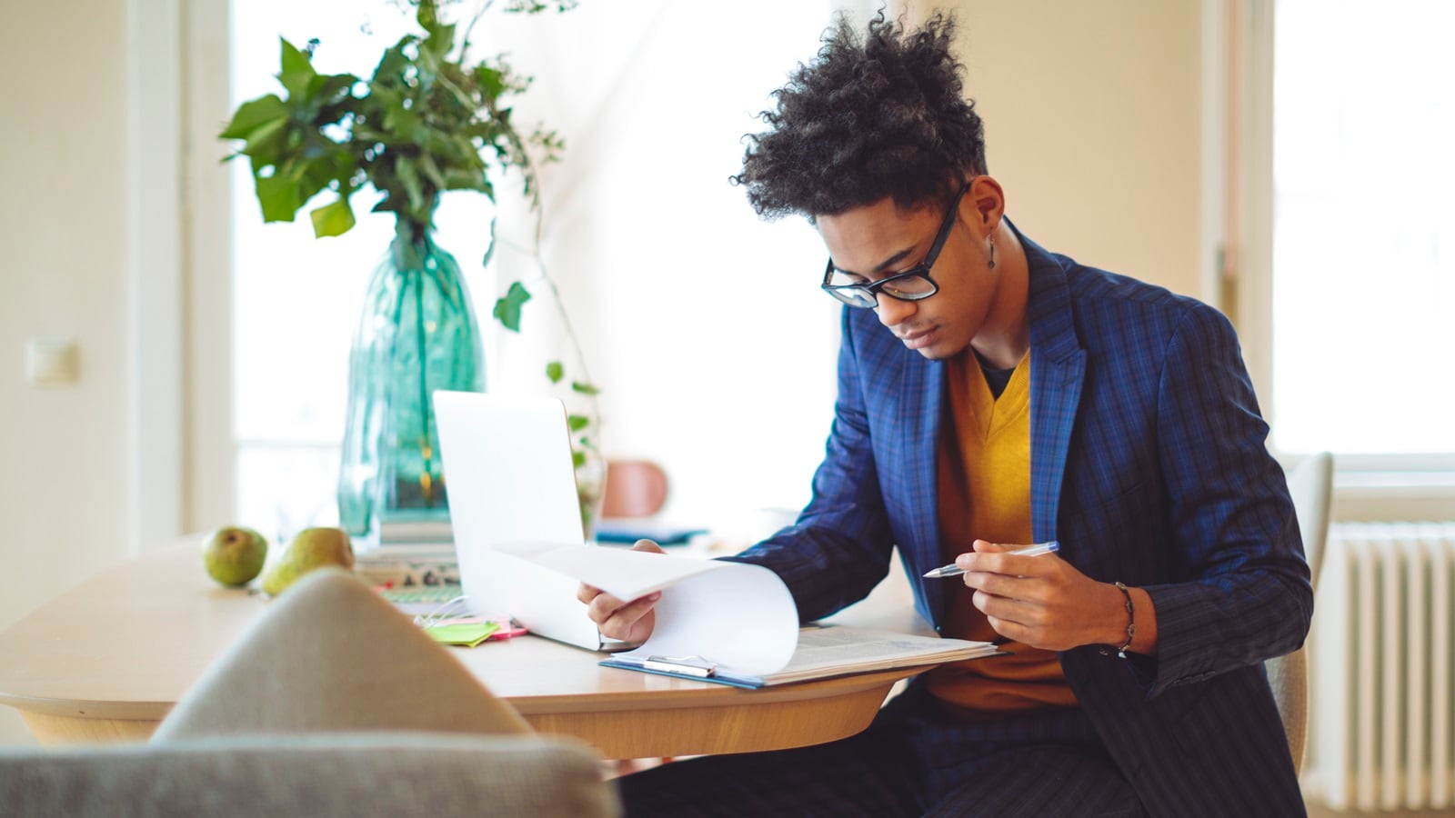 A person sitting at a table looking through papers