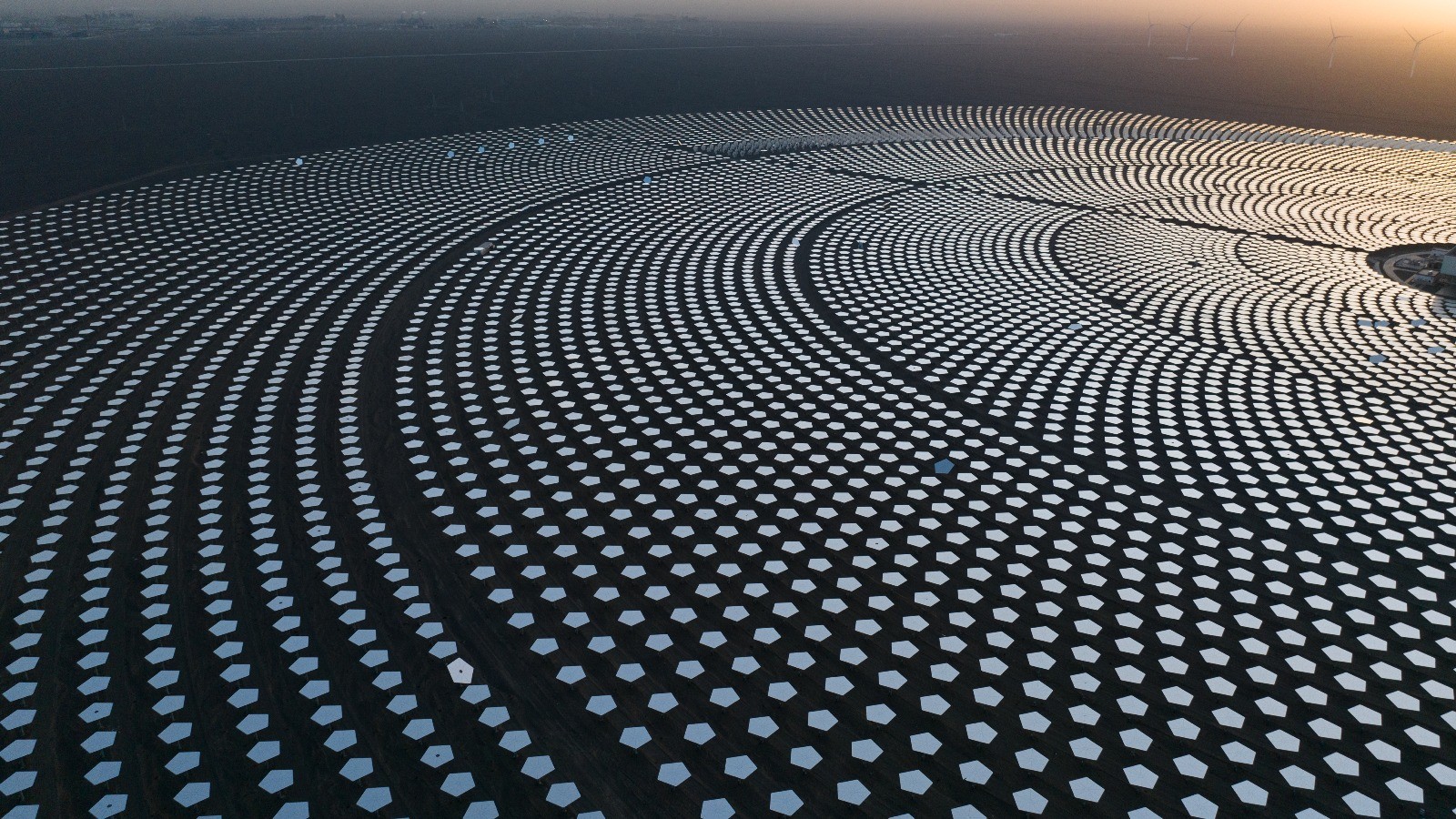 Aerial view of solar power plant with circular mirror arrays.