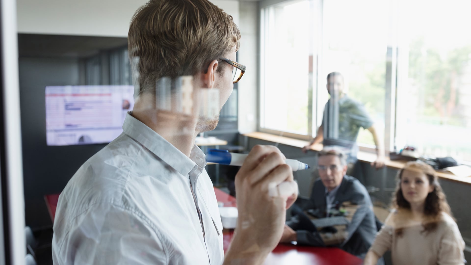 Man with marker in meeting room