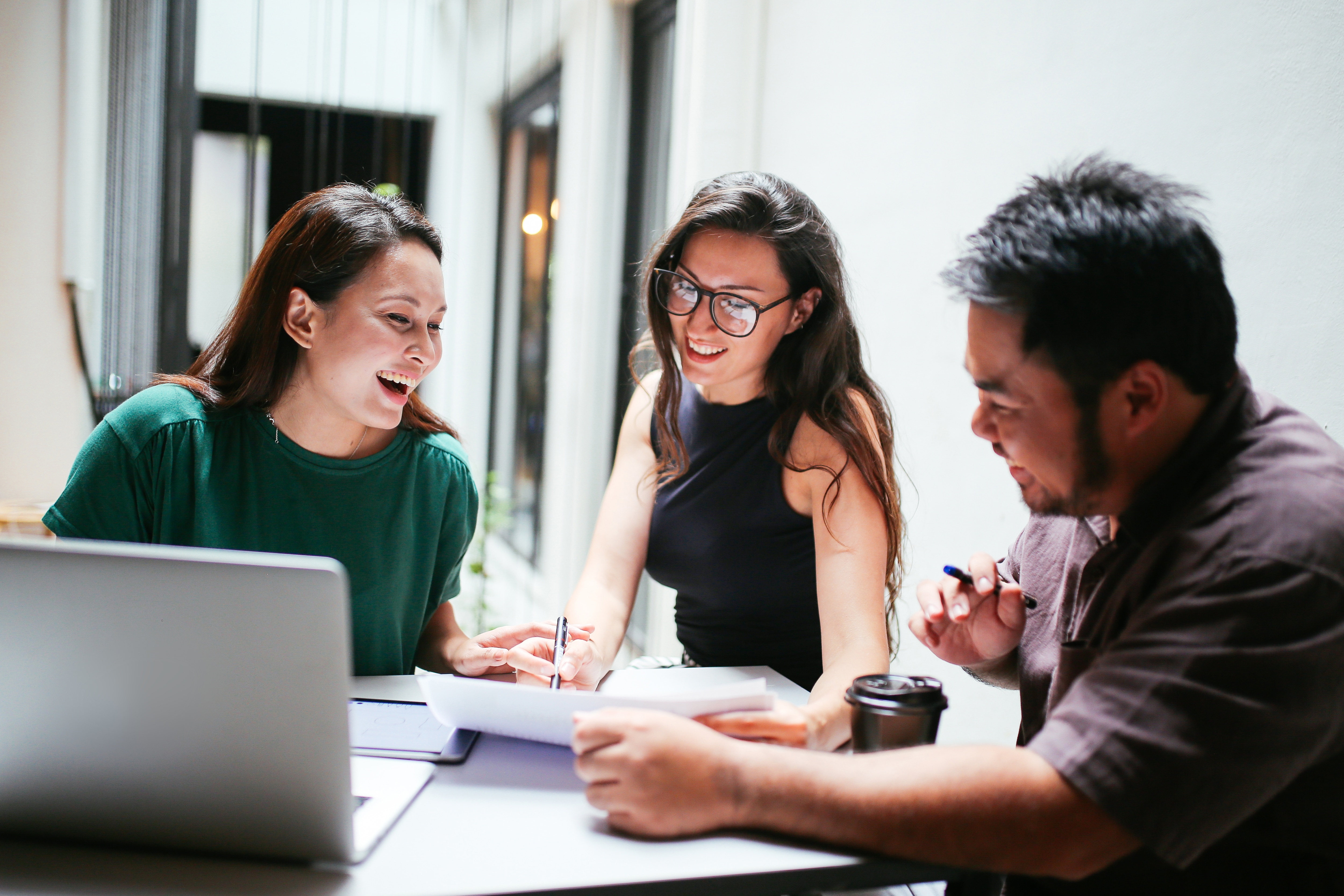A group of people in a meeting at a table