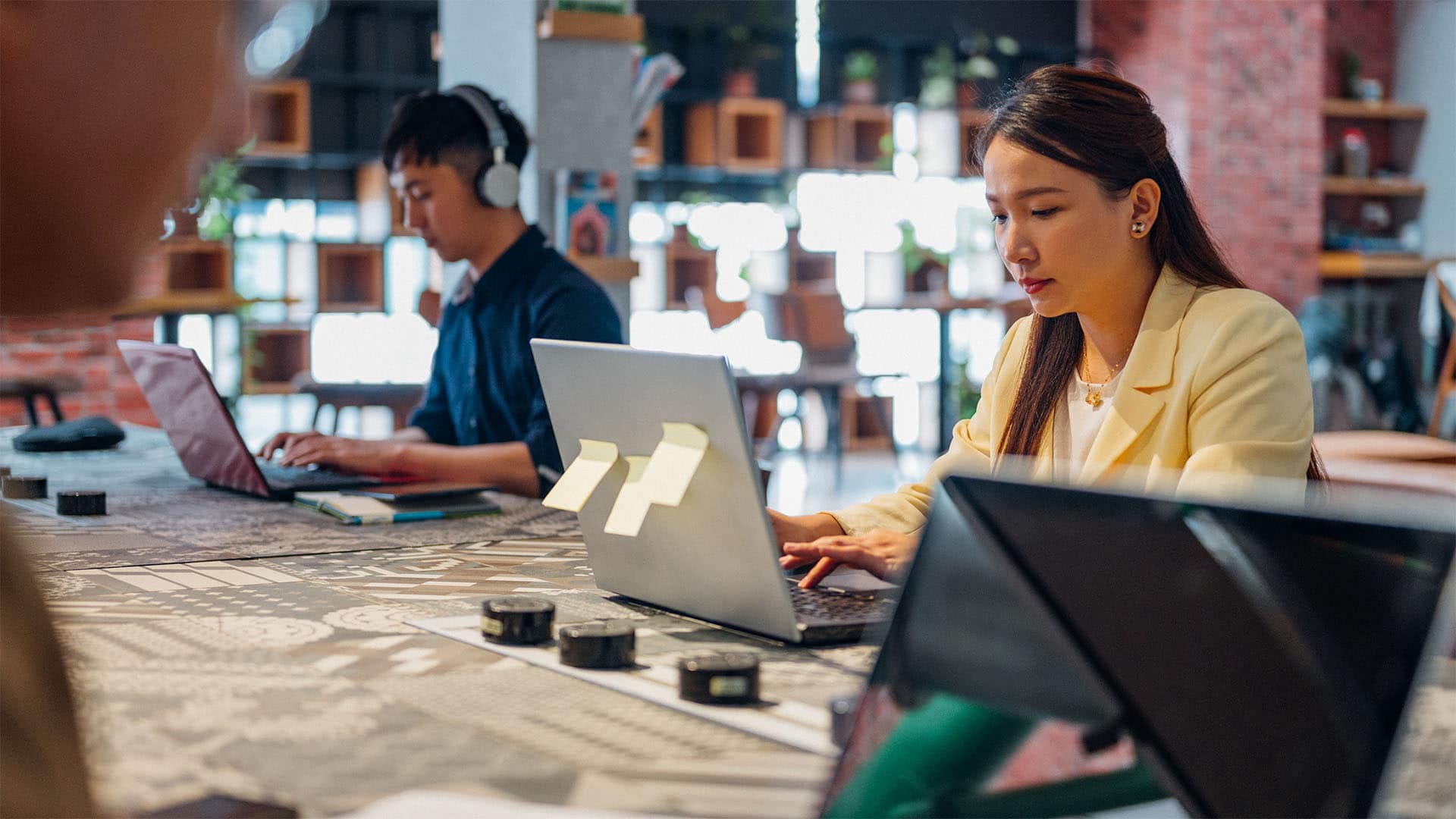 Woman working on laptop in co-working space