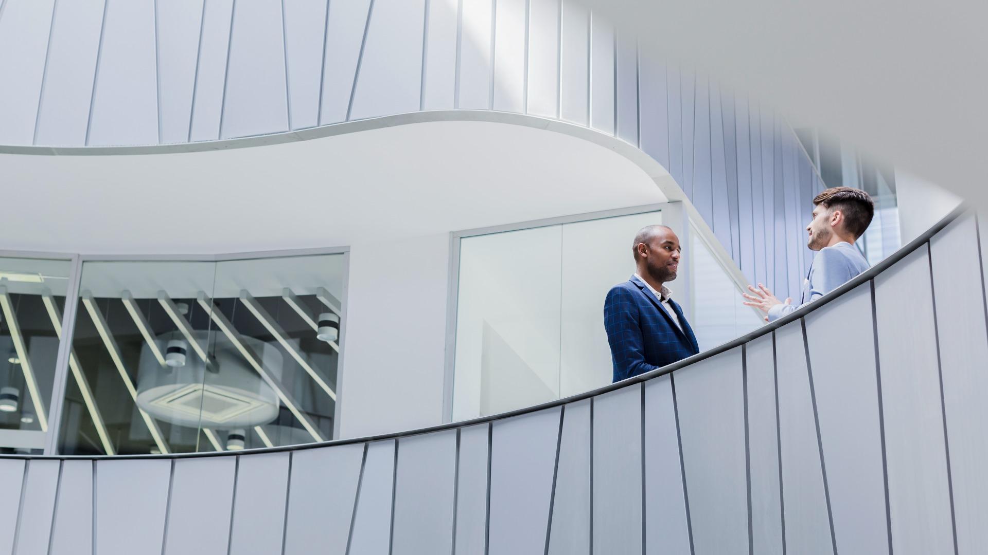 Businessmen talking on balcony