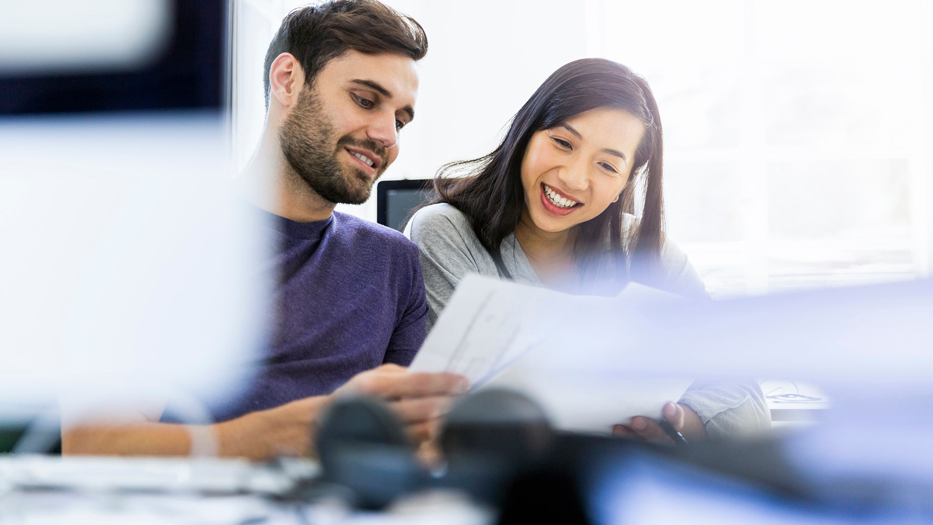 Two students looking at documents