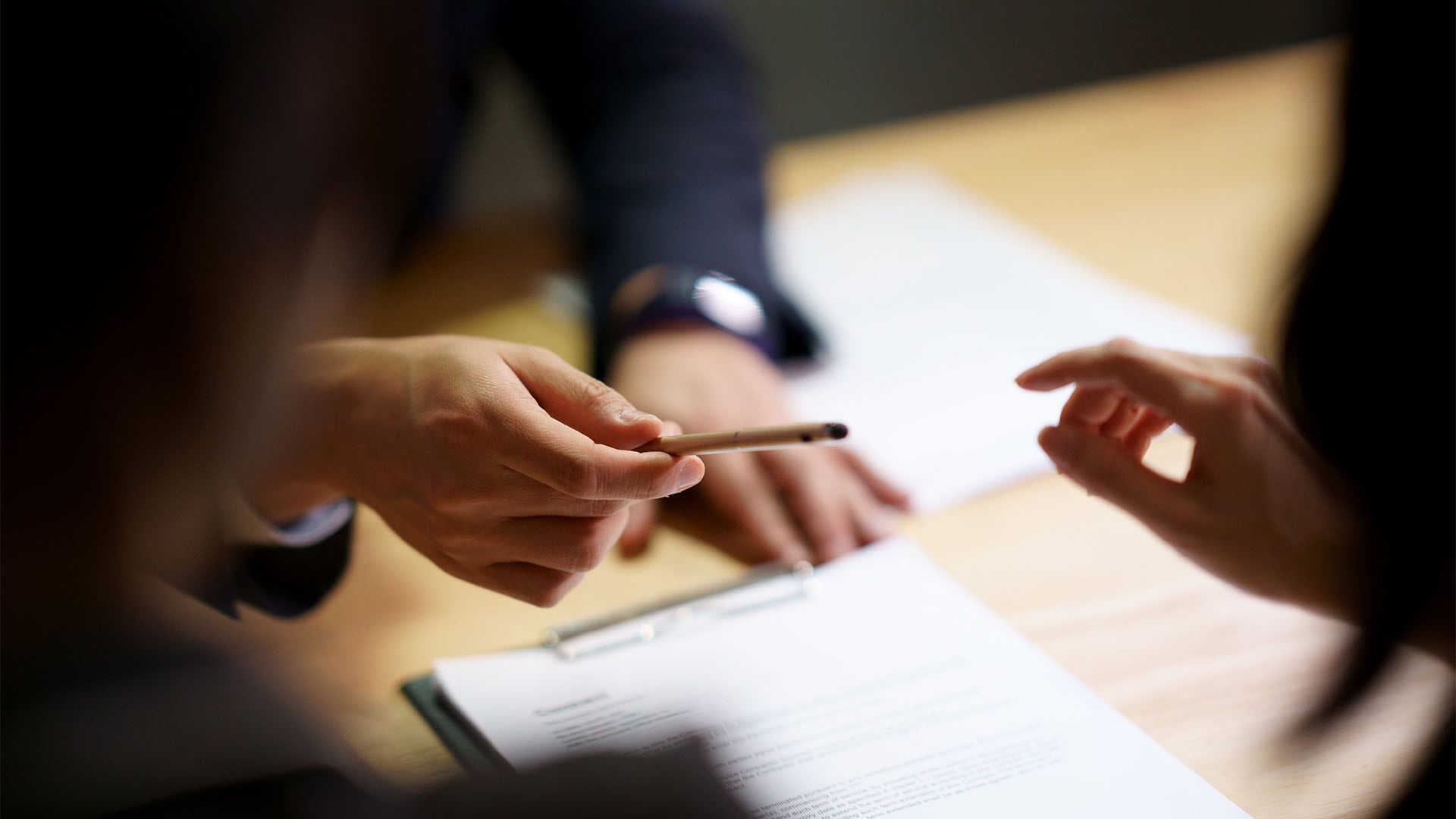 Businessman offering pen to sign contract agreement