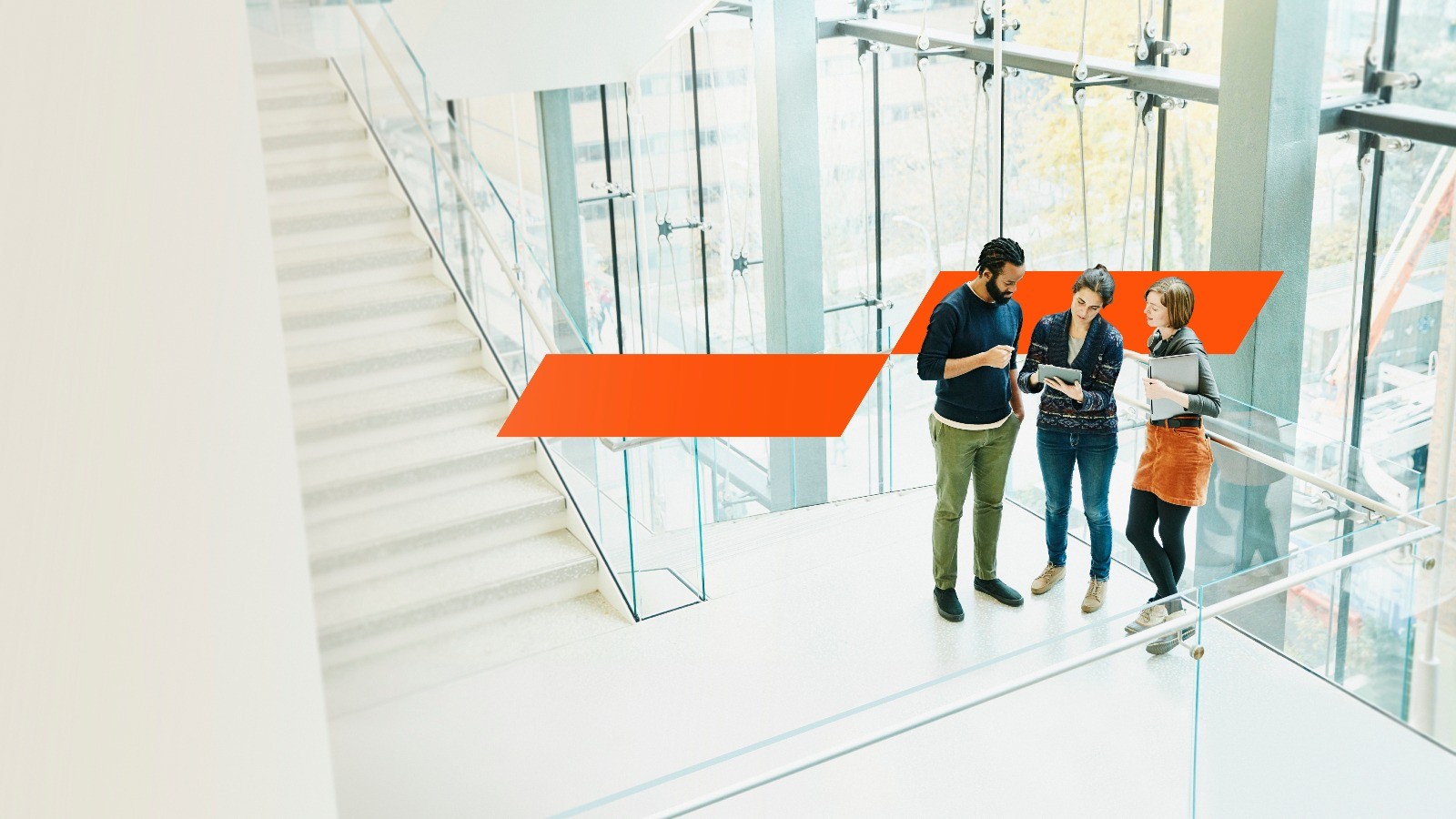 3 people standing an office building