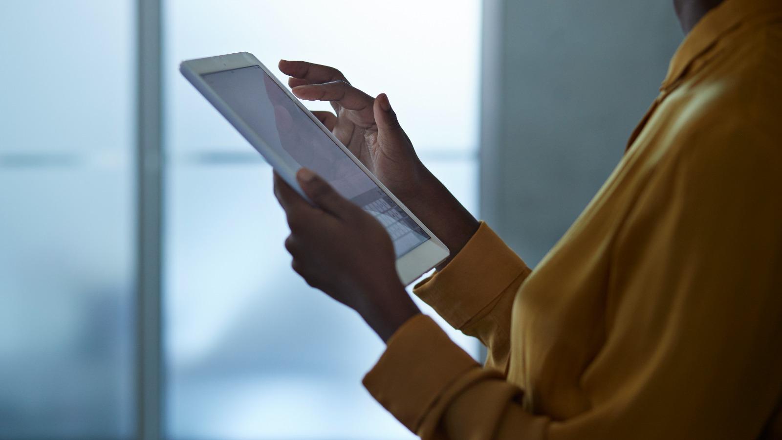 Woman working on a tablet.