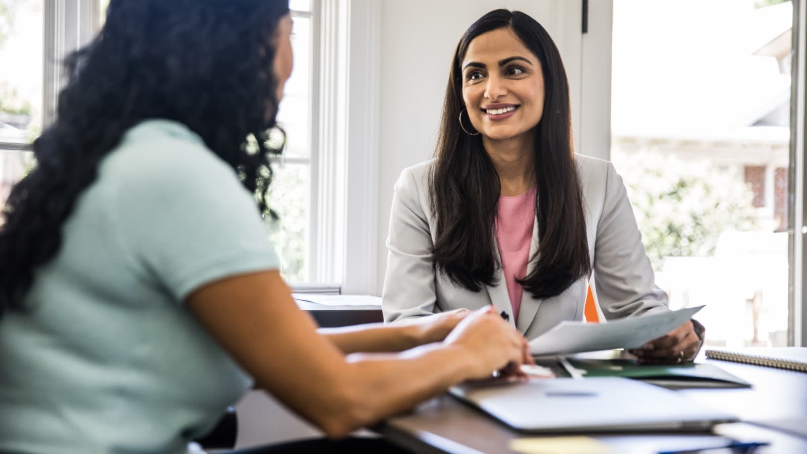 Two business women in a room having a meeting