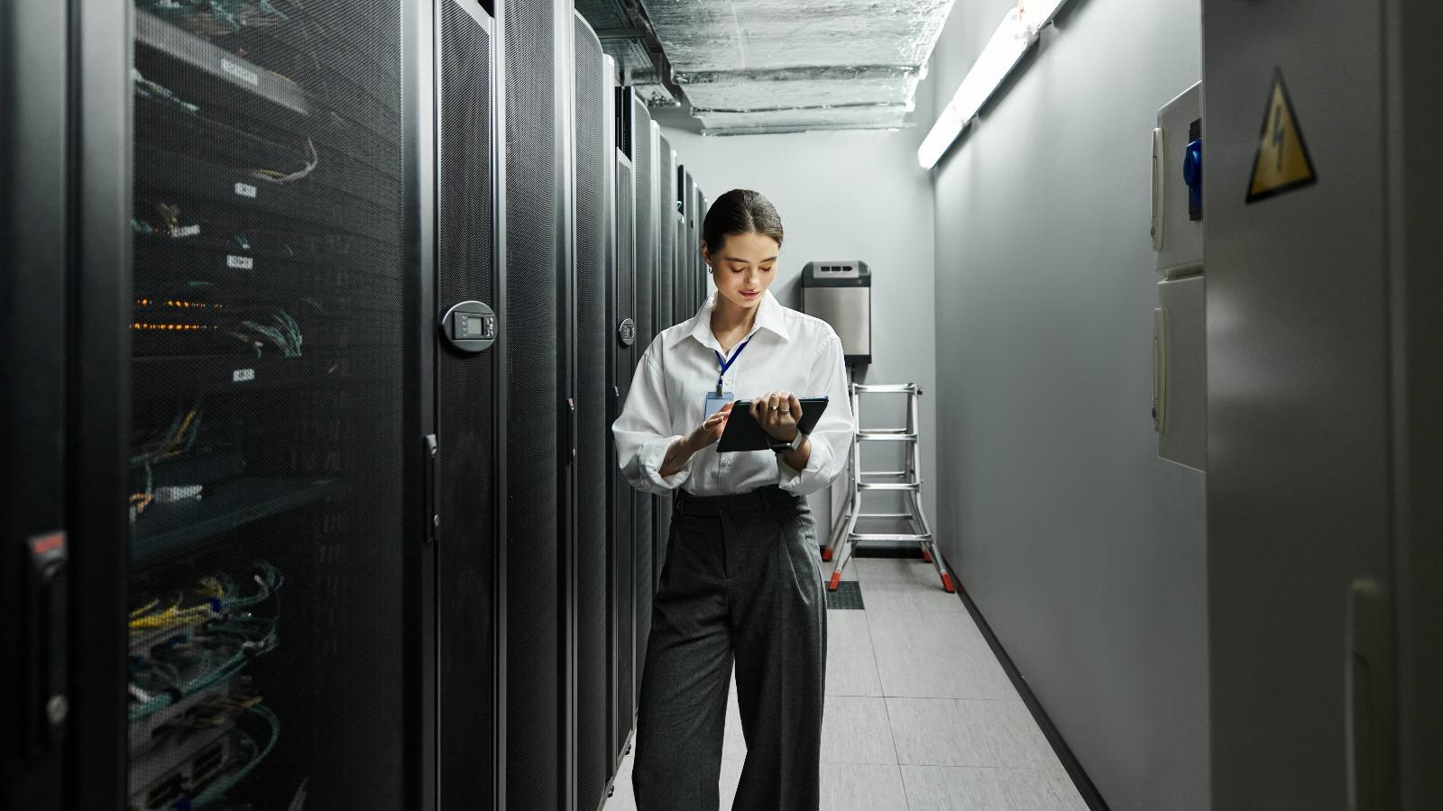 A woman standing in a data center