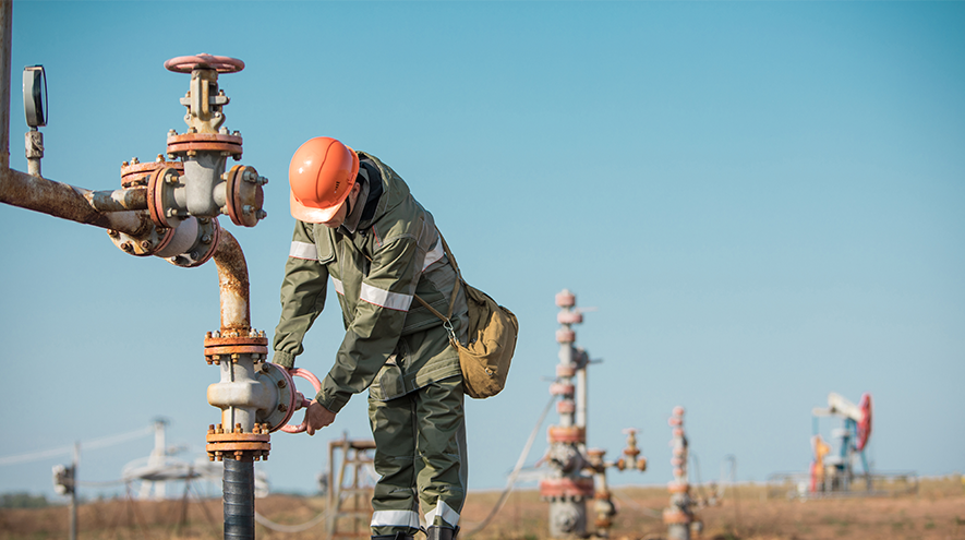 An energy worker, securing a pipe
