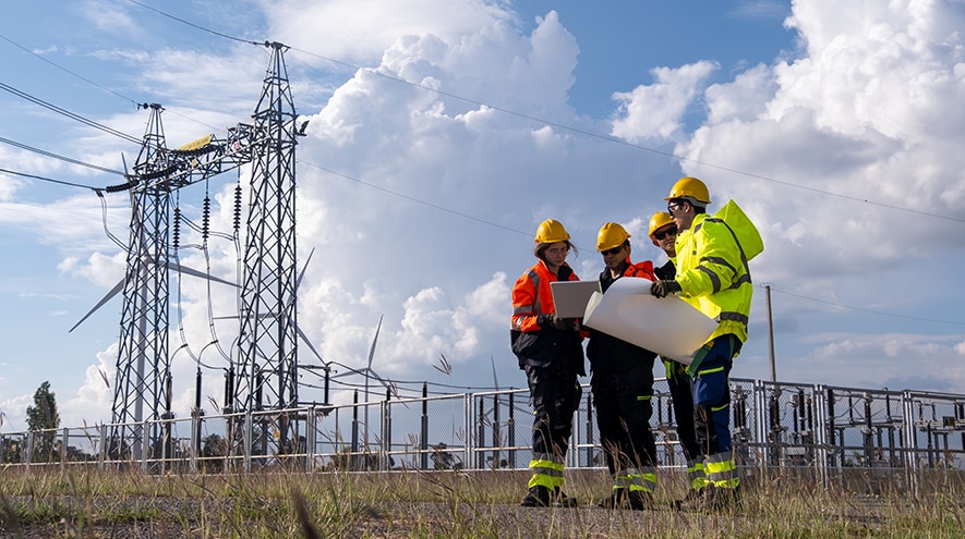 Workers checking plans at a power facility
