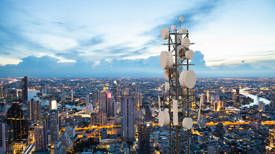 A city skyline with a communication tower