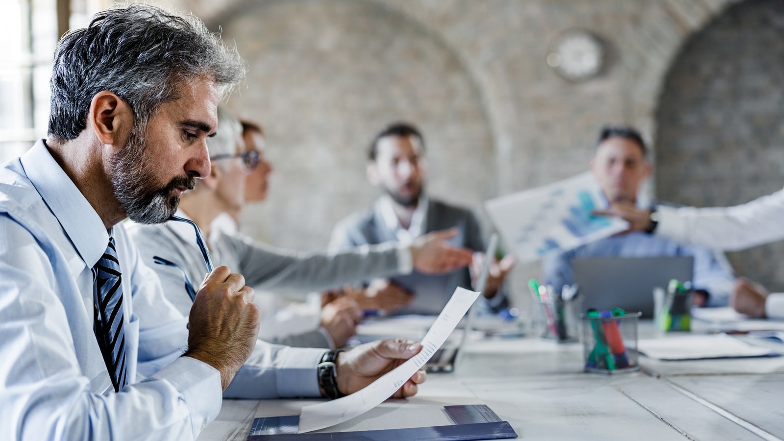 Someone taking notes during a meeting