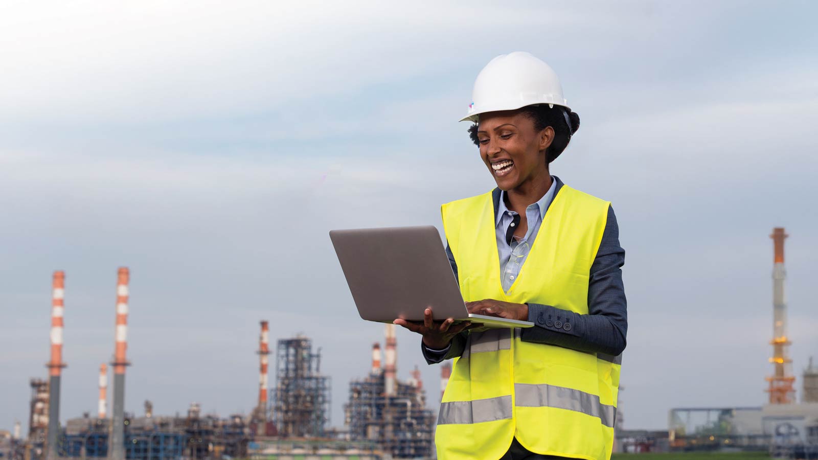 Mine worker looking at a laptop.
